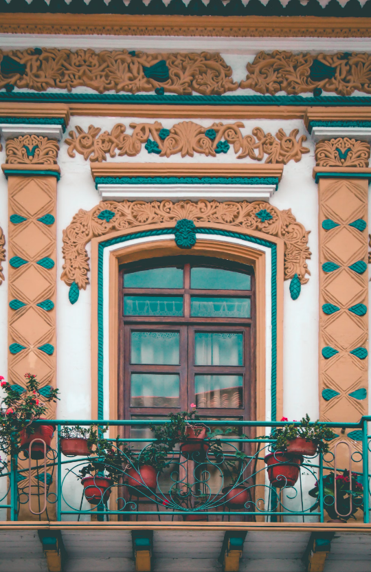 Neoclassical architecture in Europe, extravagant moldings on balcony.